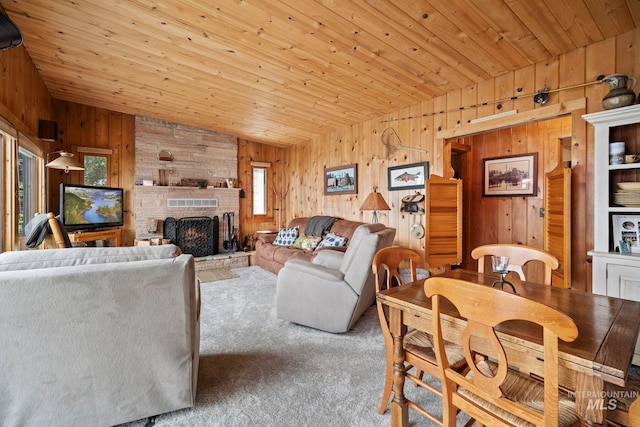 living room featuring carpet, a brick fireplace, wood ceiling, vaulted ceiling, and wooden walls