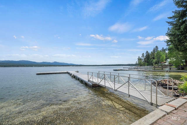 view of dock featuring a water and mountain view