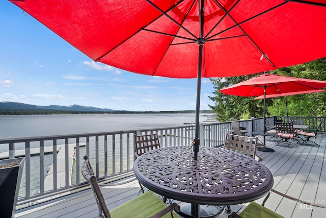 wooden terrace with a water and mountain view