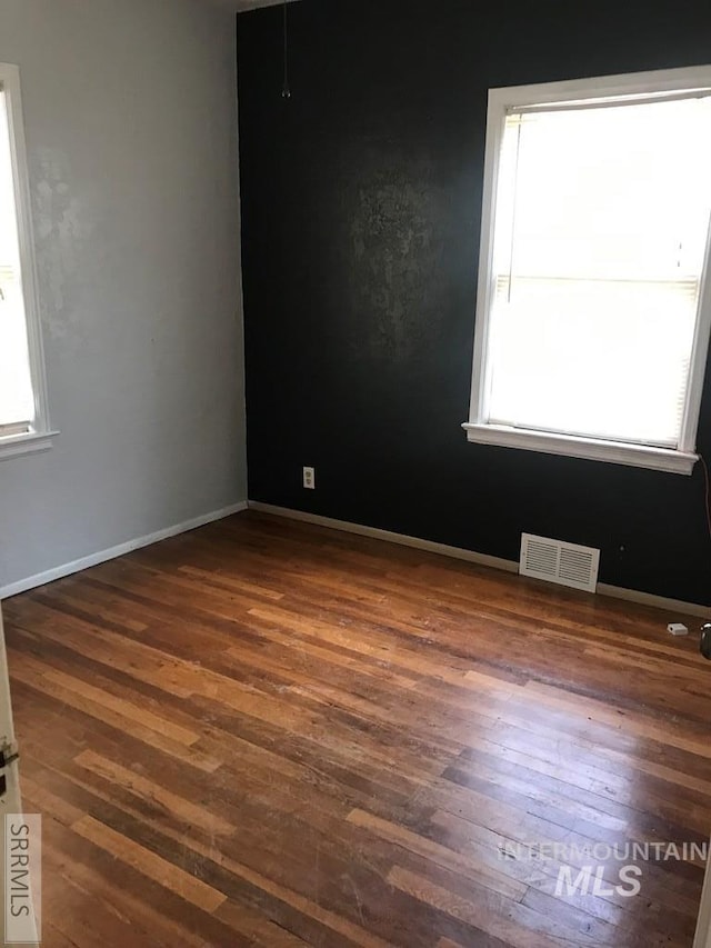 empty room with dark wood-type flooring