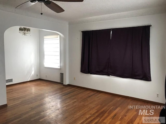 spare room with a textured ceiling, hardwood / wood-style flooring, and ceiling fan