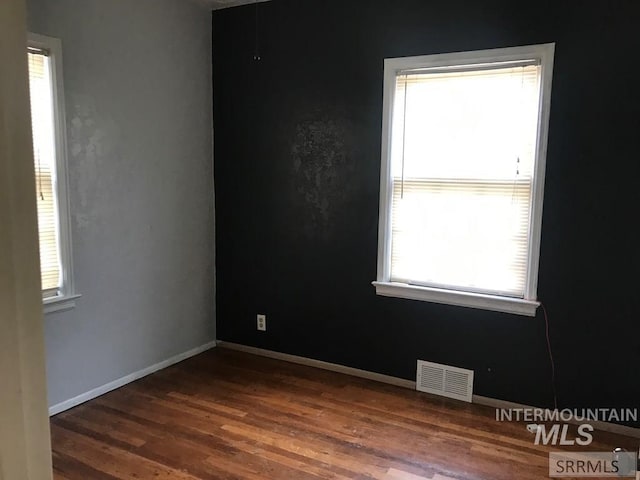 spare room featuring dark hardwood / wood-style flooring