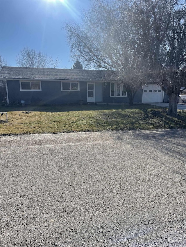 view of front of house featuring a front lawn and a garage