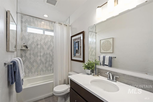 bathroom featuring visible vents, tile patterned flooring, shower / tub combo, vanity, and toilet