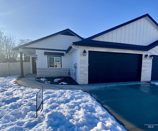 ranch-style house featuring a garage, fence, and concrete driveway