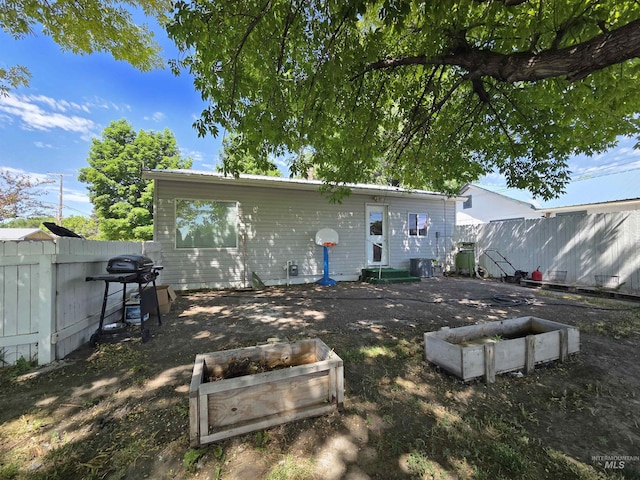 136 W 8th St, Burley, ID 83318 - rear view of property with a fenced backyard and a vegetable garden