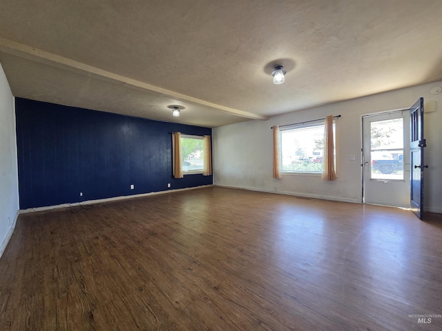 136 W 8th St, Burley, ID 83318 - empty room featuring dark wood finished floors, plenty of natural light, and a textured ceiling