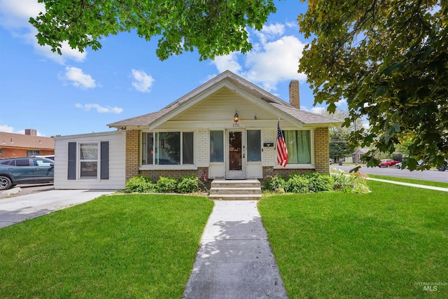 1751 Miller Ave, Burley, ID 83318 - view of front of home featuring brick siding, a front yard, and a chimney