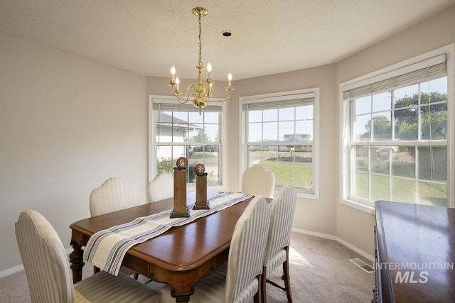 3411 Wilson Ln, Nampa, ID 83686 - carpeted dining room with a chandelier, baseboards, and healthy amount of natural light