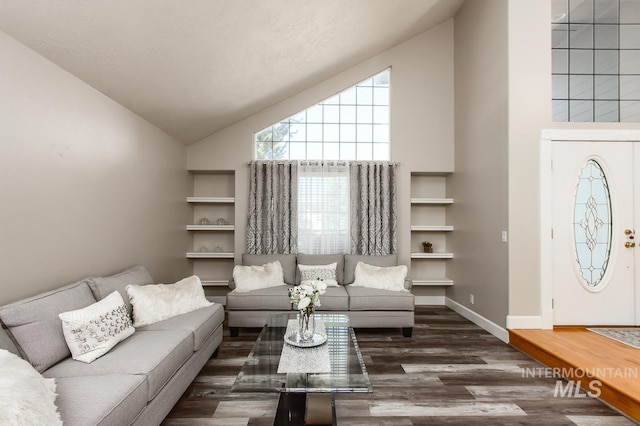 living room featuring high vaulted ceiling, wood finished floors, and baseboards