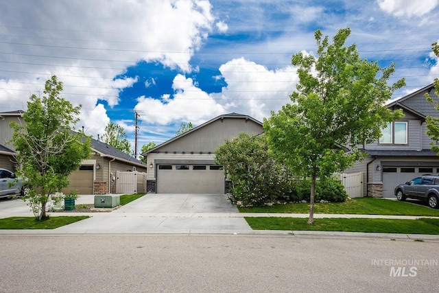3744 S Antler Rdg, Boise, ID 83709 - view of front of house with concrete driveway, stone siding, fence, and a gate