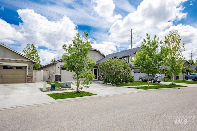 3744 S Antler Rdg, Boise, ID 83709 - view of property hidden behind natural elements featuring concrete driveway, a garage, and stone siding