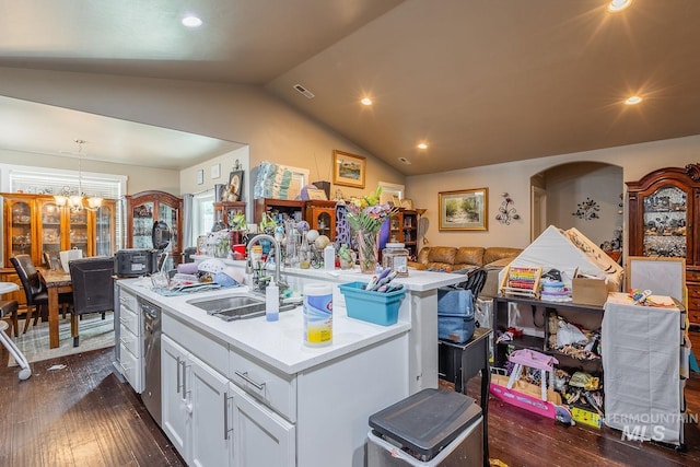 3744 S Antler Rdg, Boise, ID 83709 - kitchen with a sink, a center island with sink, vaulted ceiling, dark wood-style flooring, and light countertops