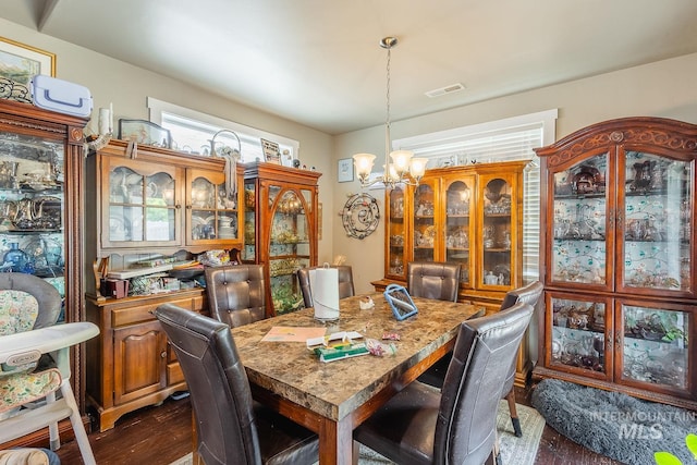 3744 S Antler Rdg, Boise, ID 83709 - dining area with a chandelier and dark wood-style flooring