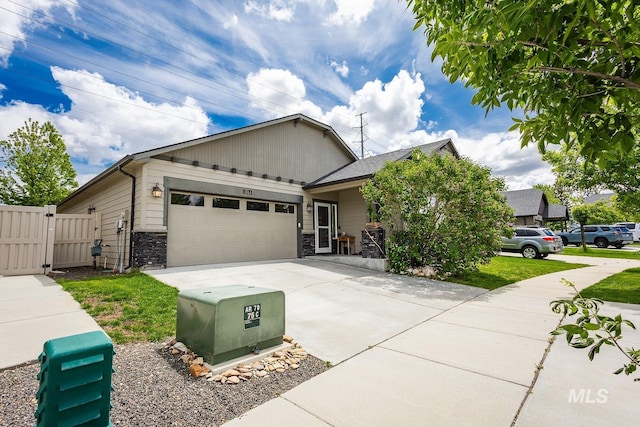 3744 S Antler Rdg, Boise, ID 83709 - view of front of property featuring concrete driveway, a garage, stone siding, a gate, and fence