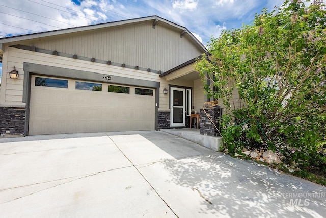 3744 S Antler Rdg, Boise, ID 83709 - view of front of house with stone siding, driveway, and an attached garage