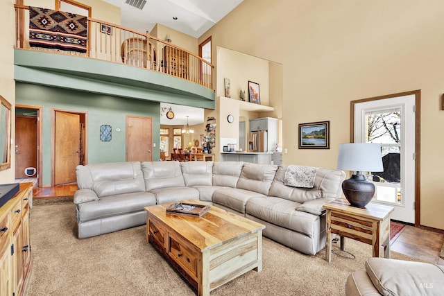 living area featuring high vaulted ceiling and healthy amount of natural light