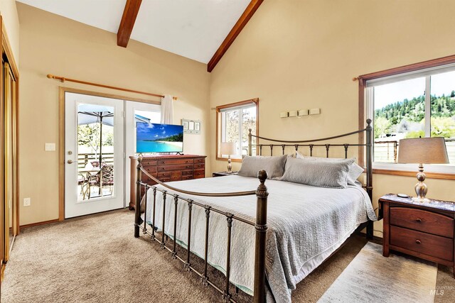 carpeted bedroom featuring access to exterior, beam ceiling, high vaulted ceiling, and baseboards