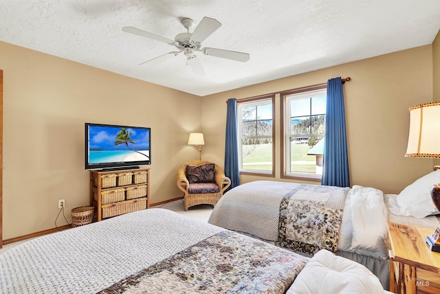 carpeted bedroom with baseboards and a ceiling fan