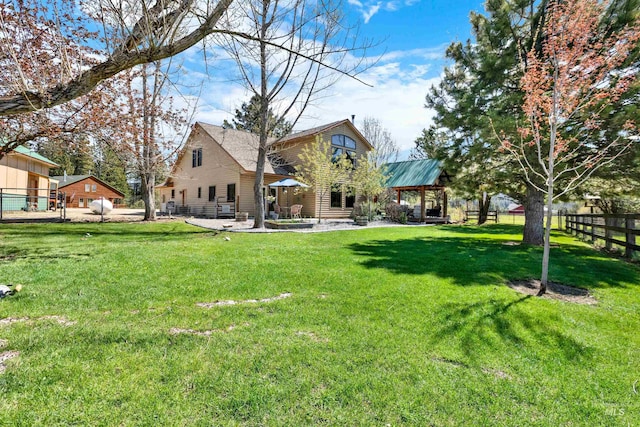 back of house with a gazebo and a patio