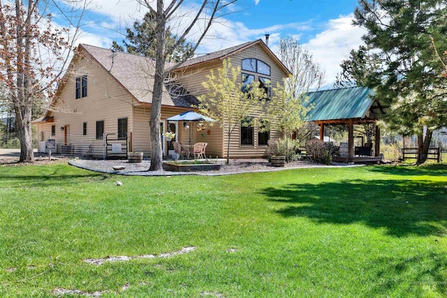 rear view of property with a lawn, a patio, and a chimney