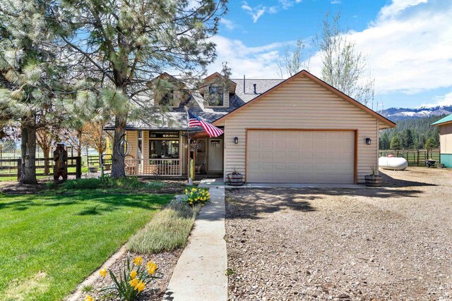 view of front of house featuring a garage, covered porch, and a shingled roof