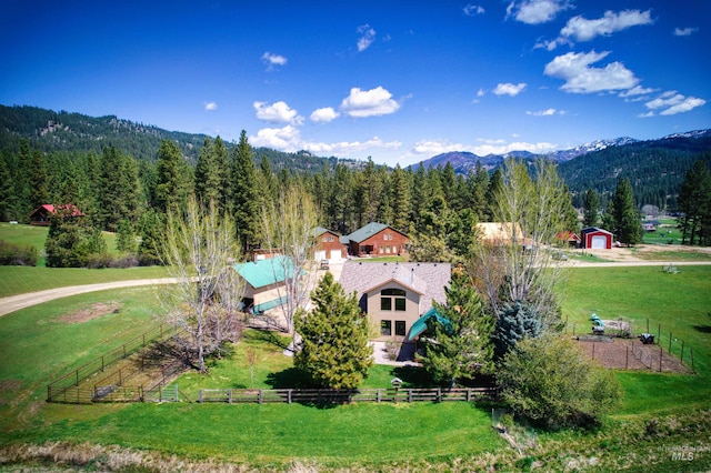 overview of rural landscape with a heavily wooded area and a mountain backdrop