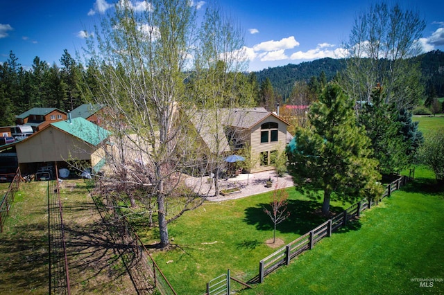 aerial view of property and surrounding area with a heavily wooded area