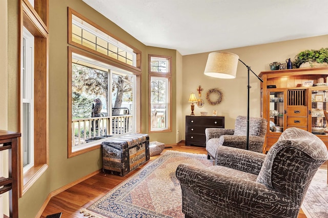 sitting room with wood finished floors and baseboards