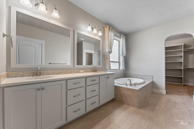 1031 E Reflect Ridge Dr, Meridian, ID 83642 - full bath with double vanity, a garden tub, and tile patterned flooring