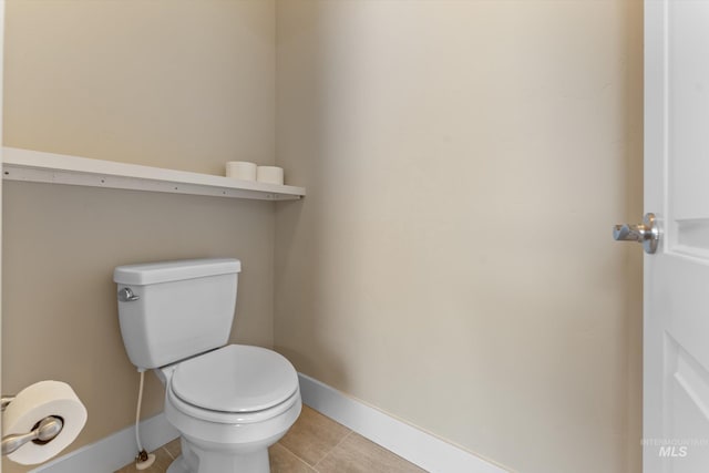1031 E Reflect Ridge Dr, Meridian, ID 83642 - bathroom with baseboards, toilet, and tile patterned floors