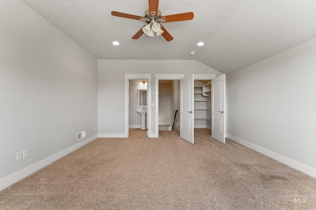 1031 E Reflect Ridge Dr, Meridian, ID 83642 - unfurnished bedroom featuring light colored carpet, baseboards, recessed lighting, a walk in closet, and vaulted ceiling