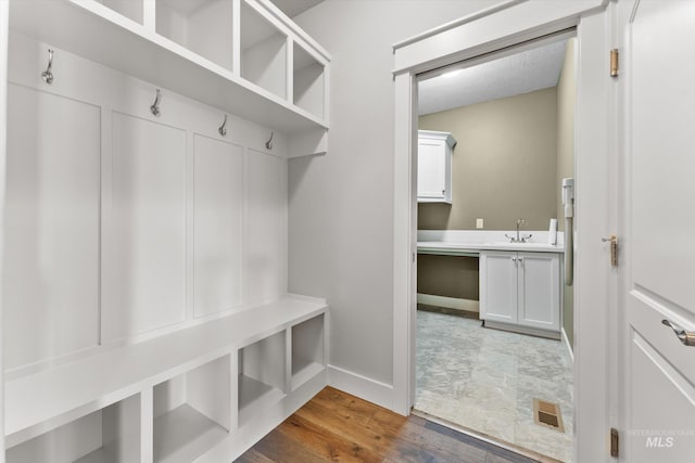 1031 E Reflect Ridge Dr, Meridian, ID 83642 - mudroom with baseboards, wood finished floors, and a sink