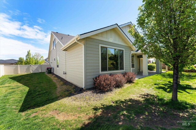 1031 E Reflect Ridge Dr, Meridian, ID 83642 - view of side of property with board and batten siding, cooling unit, a gate, and a patio area