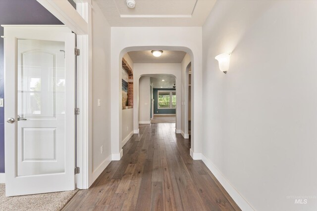 1031 E Reflect Ridge Dr, Meridian, ID 83642 - corridor featuring arched walkways, hardwood / wood-style floors, and baseboards