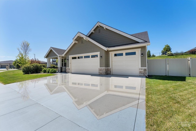 1031 E Reflect Ridge Dr, Meridian, ID 83642 - view of front of property with stone siding, an attached garage, a gate, and driveway