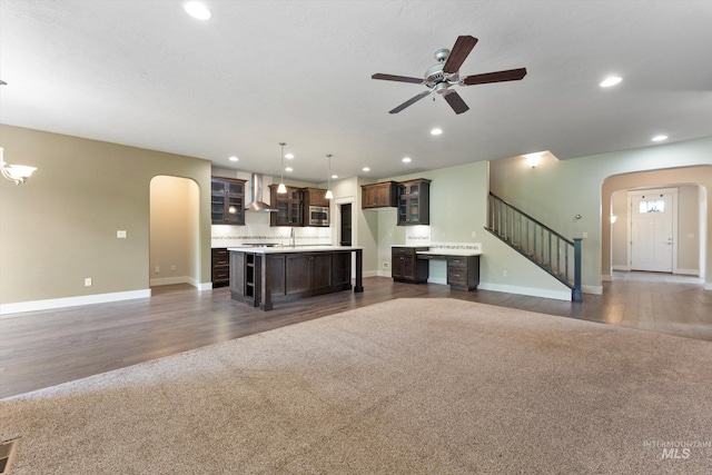 1031 E Reflect Ridge Dr, Meridian, ID 83642 - unfurnished living room featuring arched walkways, baseboards, ceiling fan, recessed lighting, and stairs