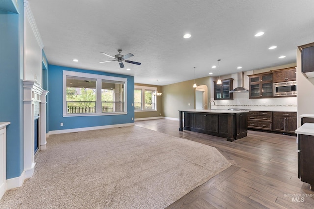 1031 E Reflect Ridge Dr, Meridian, ID 83642 - kitchen with stainless steel microwave, open floor plan, light countertops, baseboards, and ceiling fan