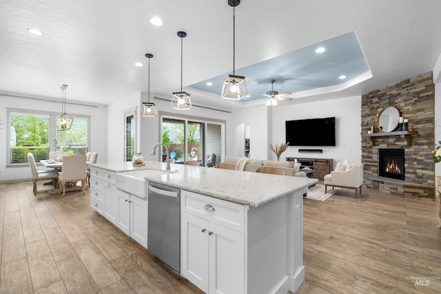 5853 W Venetian Dr, Eagle, ID 83616 - kitchen featuring stainless steel dishwasher, a sink, light wood-style flooring, white cabinets, and recessed lighting