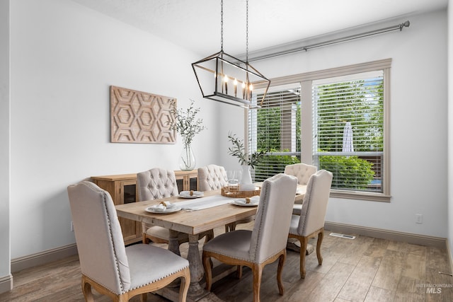 5853 W Venetian Dr, Eagle, ID 83616 - dining space with a chandelier, baseboards, and wood finished floors