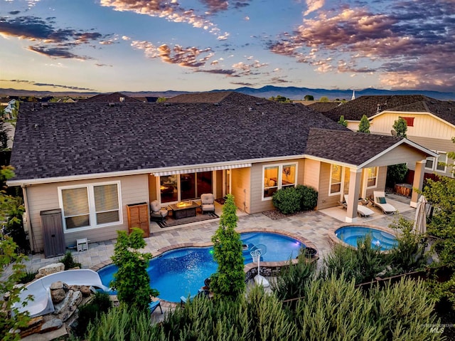 5853 W Venetian Dr, Eagle, ID 83616 - back of house with an in-ground hot tub, an outdoor hangout area, a fenced backyard, and a patio