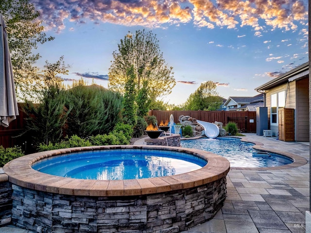 5853 W Venetian Dr, Eagle, ID 83616 - pool at dusk featuring a fenced backyard and a patio