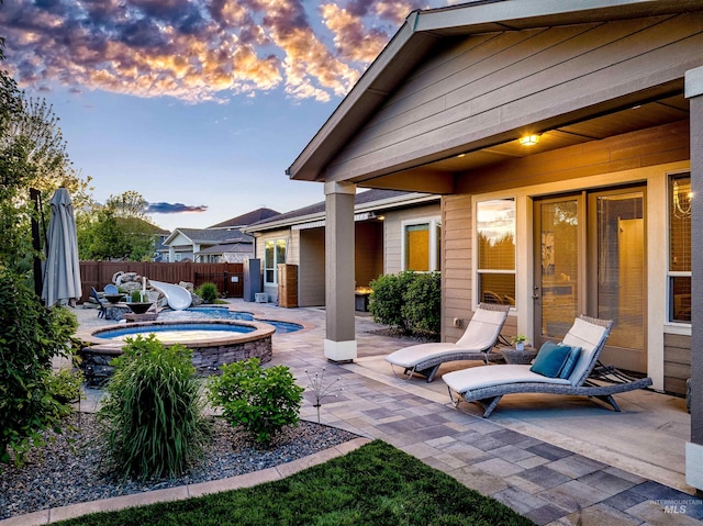 5853 W Venetian Dr, Eagle, ID 83616 - view of patio / terrace featuring an in-ground hot tub and fence