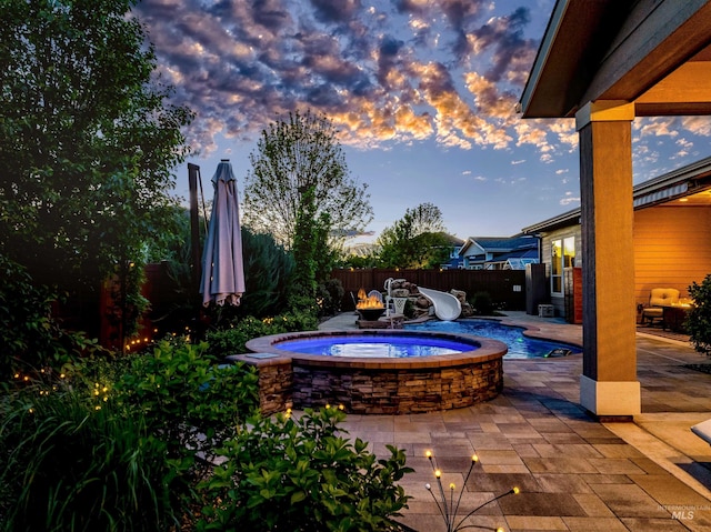 5853 W Venetian Dr, Eagle, ID 83616 - patio terrace at dusk featuring an outdoor hot tub and a fenced backyard