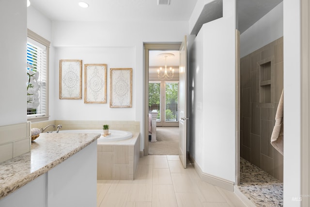 5853 W Venetian Dr, Eagle, ID 83616 - bathroom featuring a chandelier, walk in shower, a garden tub, and recessed lighting