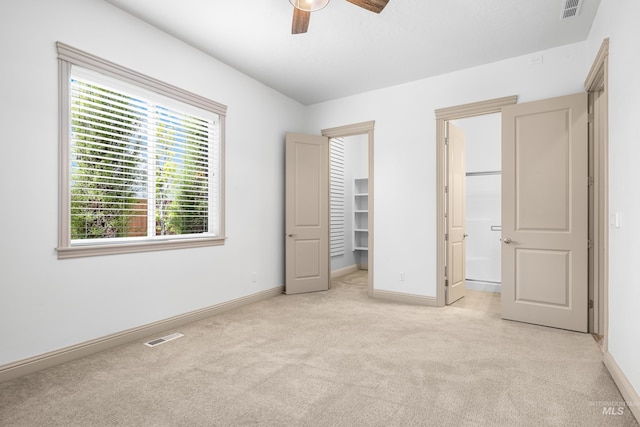 5853 W Venetian Dr, Eagle, ID 83616 - unfurnished bedroom with carpet floors, baseboards, a spacious closet, connected bathroom, and ceiling fan