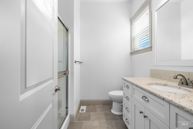 5853 W Venetian Dr, Eagle, ID 83616 - full bath with a shower with shower door, toilet, vanity, baseboards, and tile patterned floors