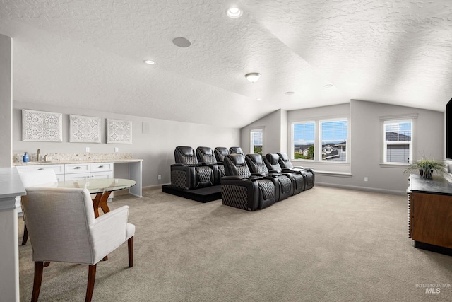 5853 W Venetian Dr, Eagle, ID 83616 - home theater room featuring light colored carpet, a textured ceiling, lofted ceiling, baseboards, and a sink