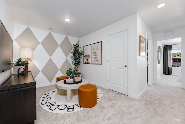 living area with light colored carpet