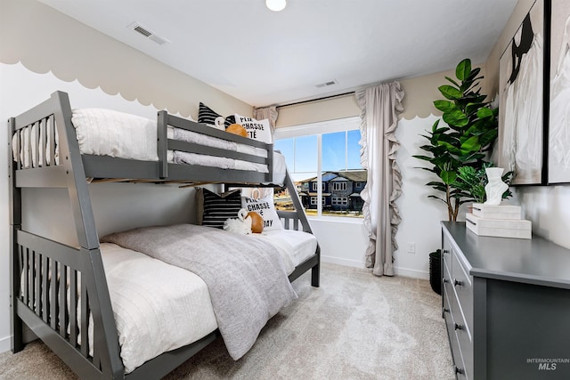 bedroom featuring light colored carpet